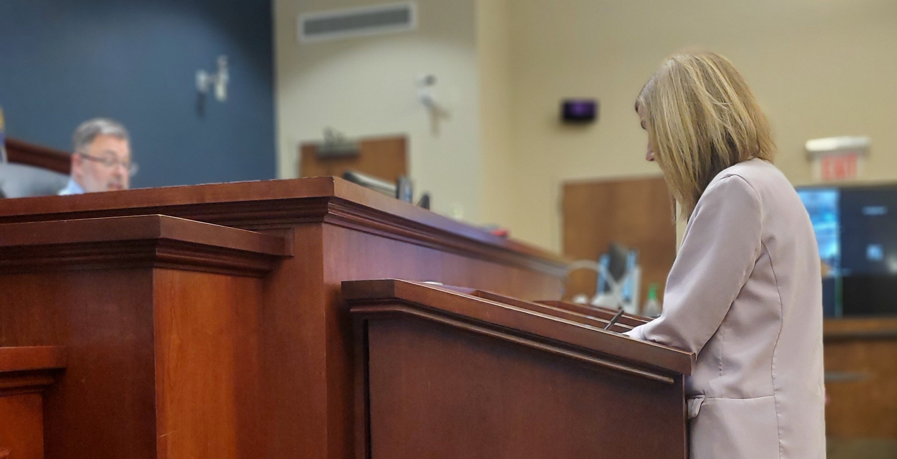 Photo of lawyer at podium in court.